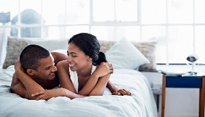 Happy Looking Couple In Bed